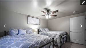 Carpeted bedroom with ceiling fan