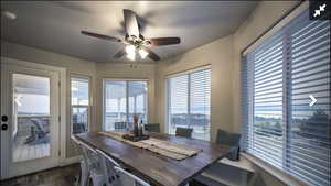 Dining area with ceiling fan and dark wood-type flooring