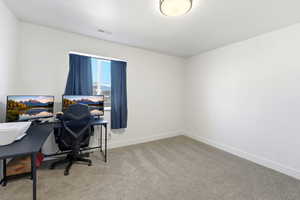 Office with light carpet and baseboards