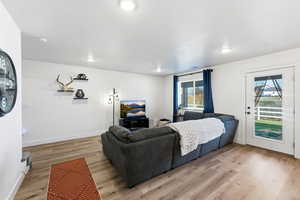 Bedroom featuring light wood-type flooring and access to exterior