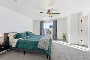 Carpeted bedroom featuring a ceiling fan and baseboards