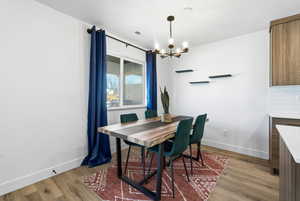Dining room featuring suspended lighting and light wood finished floors