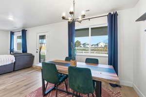 Dining room featuring wood finished floors and suspended lighting