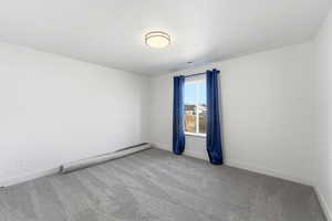 Empty room with light carpet and baseboards