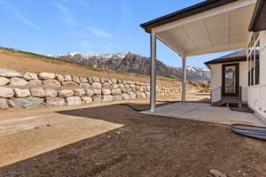 View of yard with a mountain view and a patio