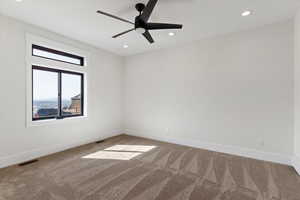 Empty room featuring ceiling fan, carpet floors, and recessed lighting