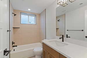 Bathroom with vanity and bathtub / shower combination