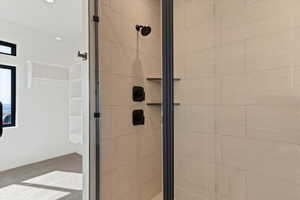 Full bathroom with a shower stall and light colored carpet