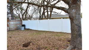 View of fenced backyard facing South West