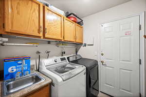 Laundry area with cabinet space and washer and dryer