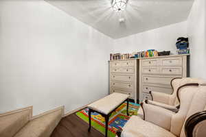 Living area with wood finished floors and a textured ceiling