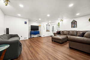 Living room featuring wood finished floors and recessed lighting