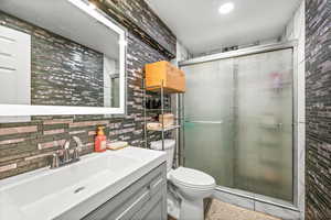 Full bathroom with vanity and a shower stall