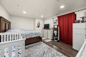 Bedroom featuring dark wood-style floors and recessed lighting