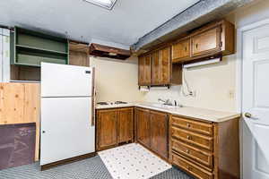 Kitchen featuring white appliances, light countertops, exhaust hood, and open shelves