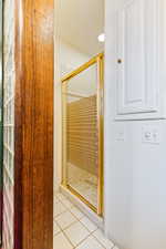 Bathroom with a stall shower, light tile patterned floors, and recessed lighting