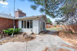 View of home's exterior with a chimney and brick siding