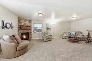 Rec room featuring a fireplace and carpet