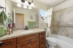 Full bath featuring vanity and shower / tub combo with curtain
