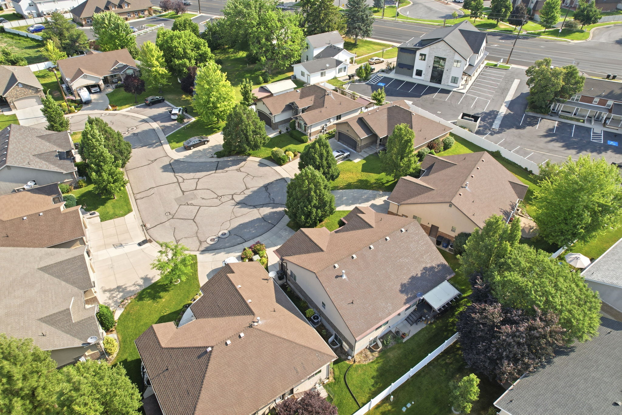 Aerial perspective showcasing a residential area with multiple homes featuring brown shingle roofs