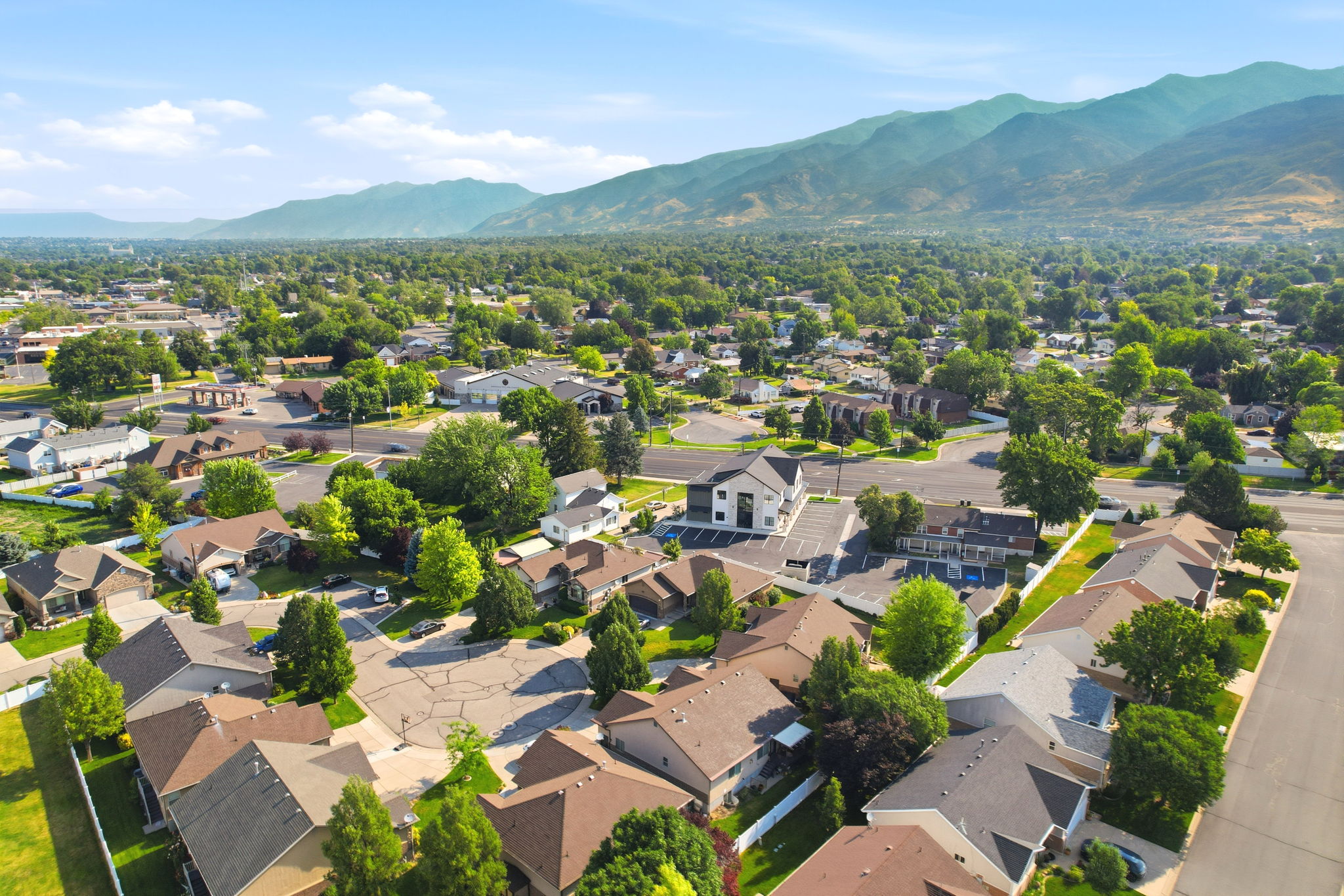 Aerial perspective showcasing a residential neighborhood with surrounding foothills and mountains