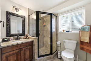 Bathroom featuring a stall shower and vanity