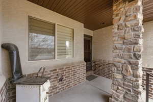 Property entrance featuring stucco siding and stone siding