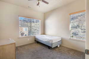 Bedroom featuring dark colored carpet and ceiling fan