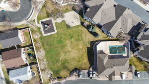 Aerial view of clubhouse with pool, open green space, play ground and basketball court