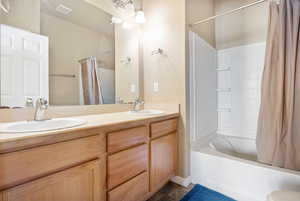 Bathroom with shower / bath combo and double vanity