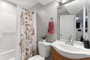Bathroom with vanity and shower / bathtub combination with curtain