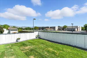 Fenced backyard featuring a residential view