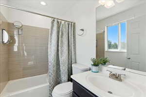 Full bath featuring vanity and shower / tub combo