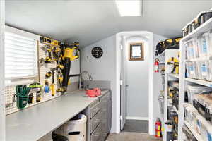 Kitchen with light countertops and concrete flooring