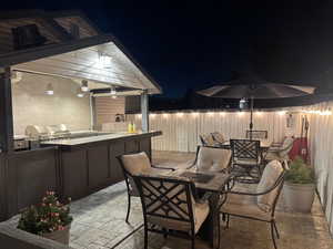 Fenced backyard with an outdoor kitchen / dining area and a patio area
