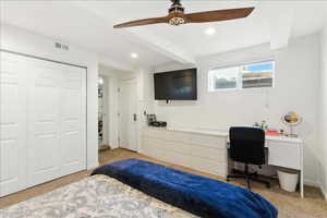 Bedroom with light colored carpet, recessed lighting, a desk, a ceiling fan, and a closet