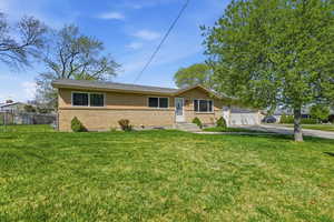 Single story home featuring brick siding, concrete driveway, and a garage