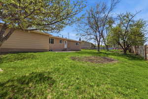 Back of house with a fenced backyard and crawl space