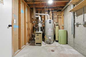 Utility room featuring water heater and Boiler. Boiler has been well maintained and works great