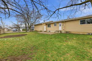 Back of property featuring a patio area, a yard, and entry steps Fully fenced