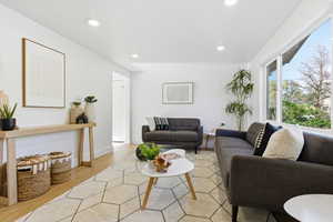 Living area featuring light wood-style flooring and recessed lighting
