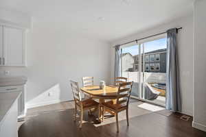 Dining room with baseboards and dark wood-type flooring