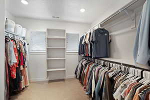 Walk in closet with light carpet