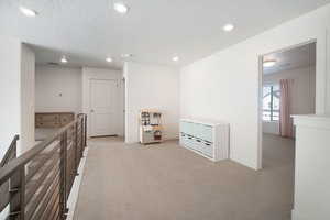 Rec room with light carpet, recessed lighting, and a textured ceiling