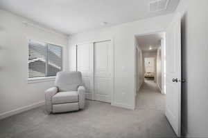 Sitting room featuring light carpet and baseboards