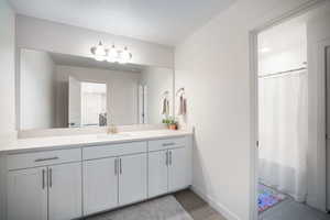 Bathroom with vanity and curtained shower