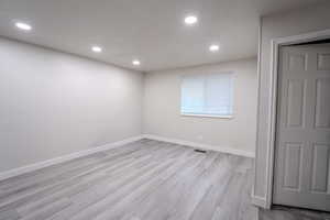 Spare room with light wood-type flooring and recessed lighting