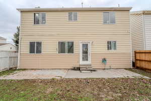 Rear view of property featuring a patio area, a fenced backyard, and entry steps