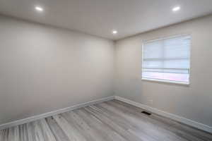 Unfurnished room featuring light wood-type flooring and recessed lighting