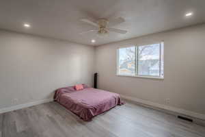 Bedroom featuring recessed lighting, light wood-style flooring, and ceiling fan